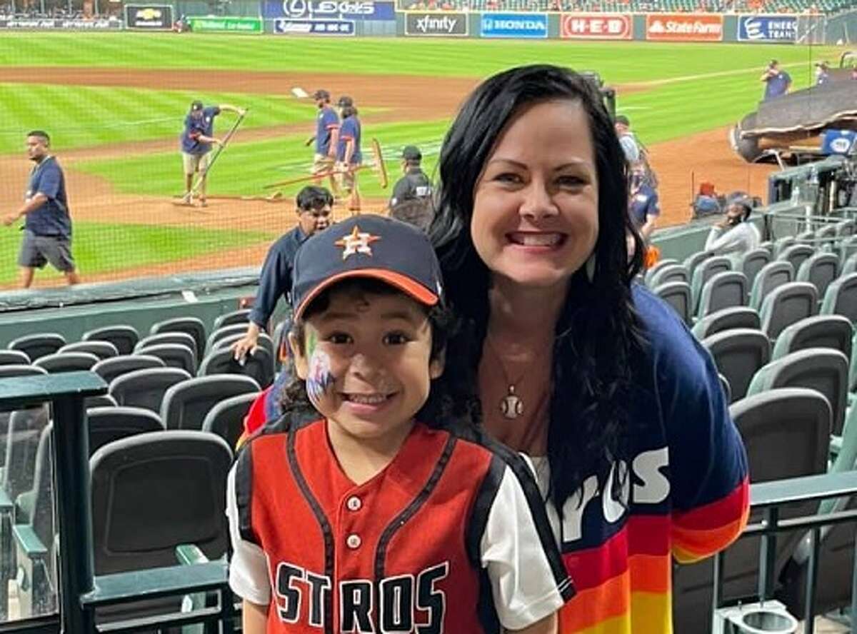 A young fan waits for Houston Astros mascot Orbit to take the