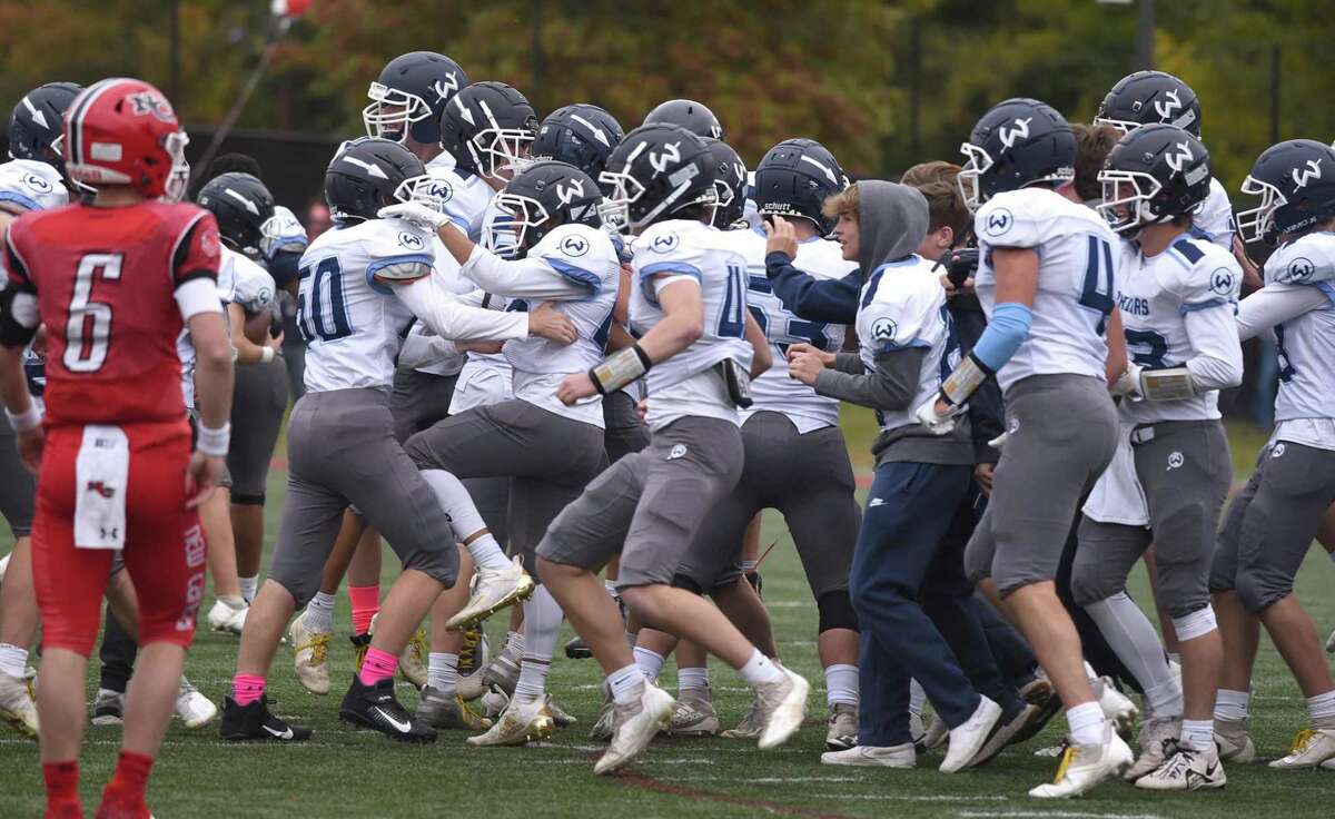 Wilton celebrates its first football win over New Canaan since 1995 at Dunning Field on Saturday in New Canaan.