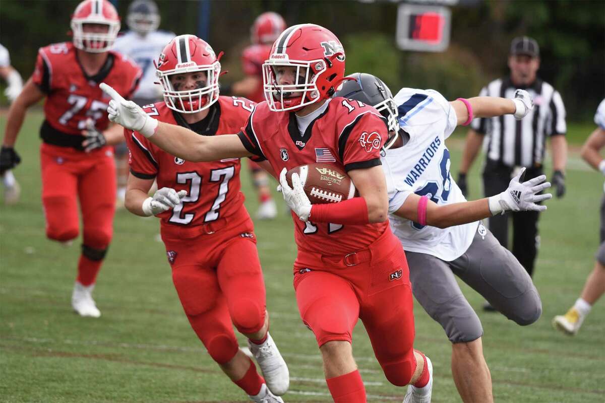 New Canaan's Mack Seelert (17) scores a touchdown against Wilton during a football game at Dunning Field on Saturday, Oct. 23, 2021