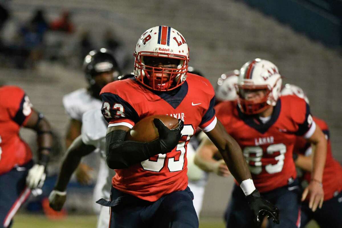 Lamar’s Kenneth Kennedy (33) runs the ball against Westside during a District 18-6A high school football game Saturday, Oct. 23, 2021, at Delmar Stadium in Houston.