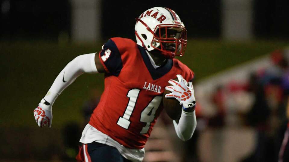 Lamar's Jordan Reaves (14) runs the ball against Westside during a District 18-6A high school football game Saturday, Oct. 23, 2021, at Delmar Stadium in Houston.