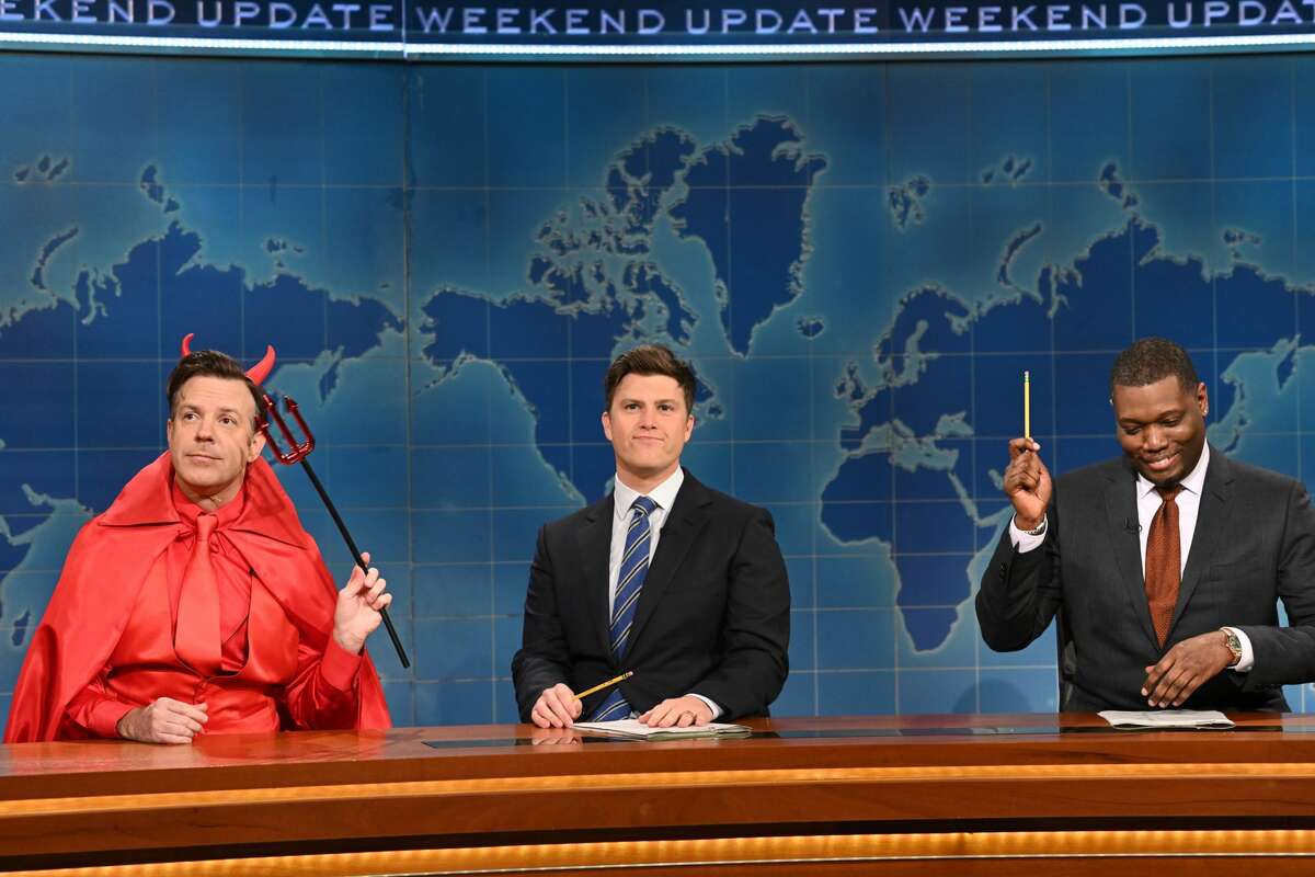 Host Jason Sudeikis as The Devil, anchor Colin Jost, and anchor Michael Che during Weekend Update on Saturday, October 23, 2021.