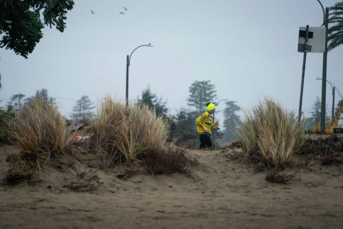 A runner did not let the inclement weather stop a morning workout on Park Street in Alameda, Calif on Sunday, October 24, 2021. Heavy rain was forecasted to inundate the Bay Area for most of the overnight hours into the day.