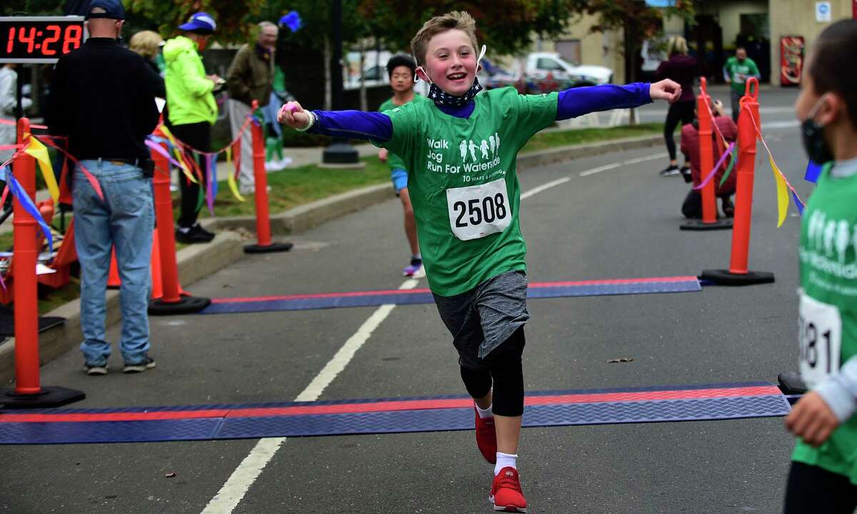 3rd grader Connor Angelo comes in second in the 1K race as students, parents, alumni and school faculty join with board members and community supporters for the 10th annual Run for Waterside Saturday, in Stamford. The 5K run, which may attracted few hundred participants start from Waterside School grounds and continue around Harbor Point. Others took part in the special event virtually. The event raises funds for the Jeff Long Endowment Fund, which was established in 2018 in memory of Long, a former Greenwich resident, Brunswick School alumni and member of Waterside School’s Associate Board. Proceeds provide scholarship support for Waterside students.