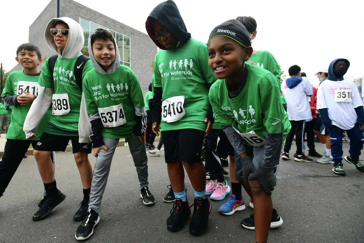 Students including 5th grader like Caiden Lampkin, right, parents, alumni and school faculty join with board members and community supporters for the 10th annual Run for Waterside Saturday, October 23, 2021, in Stamford, Conn. The 5K run, which may attracted few hundred participants start from Waterside School grounds and continue around Harbor Point. Others took part in the special event virtually. The event raises funds for the Jeff Long Endowment Fund, which was established in 2018 in memory of Long, a former Greenwich resident, Brunswick School alumni and member of Waterside School’s Associate Board. Proceeds provide scholarship support for Waterside students.