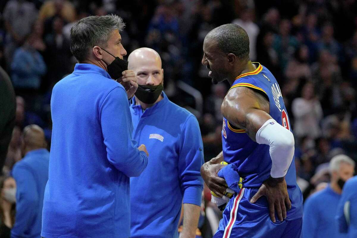 Golden State Warriors forward Andre Iguodala (9) holds his hip as he talks with team trainers during the second half against the Los Angeles Clippers in an NBA basketball game in San Francisco, Thursday, Oct. 21, 2021. The Warriors won 115-113. (AP Photo/Tony Avelar)