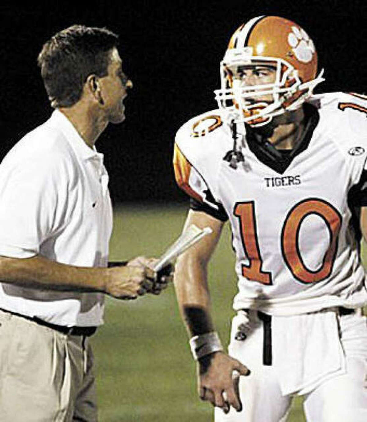 Former Edwardsville coach Tim Dougherty, left, talks to EHS quarterback Joe Allaria during a game in 2006.