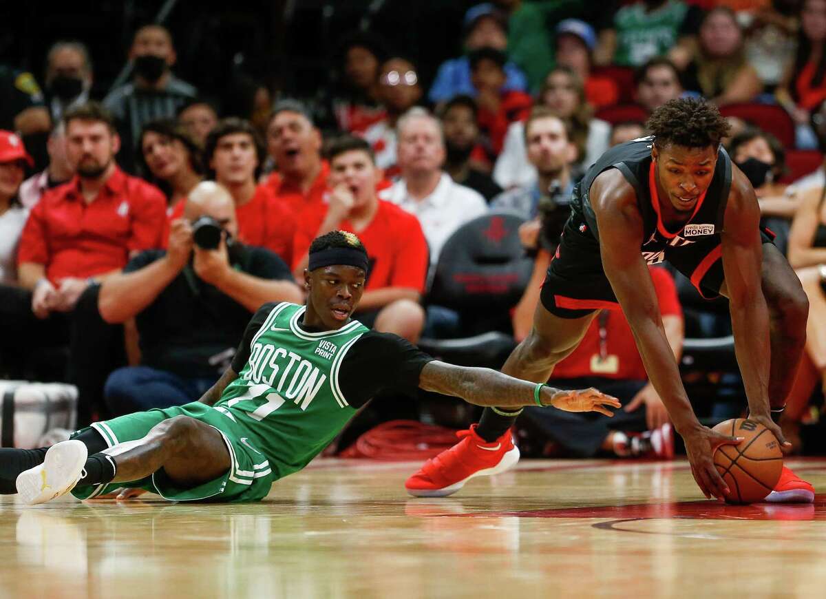 Houston Rockets forward Jae'Sean Tate (8) wins possession of a loose ball against Boston Celtics guard Dennis Schroder (71) during the second half of an NBA game at the Toyota Center on Sunday, Oct. 24, 2021, in Houston. The Celtics won 107-97.