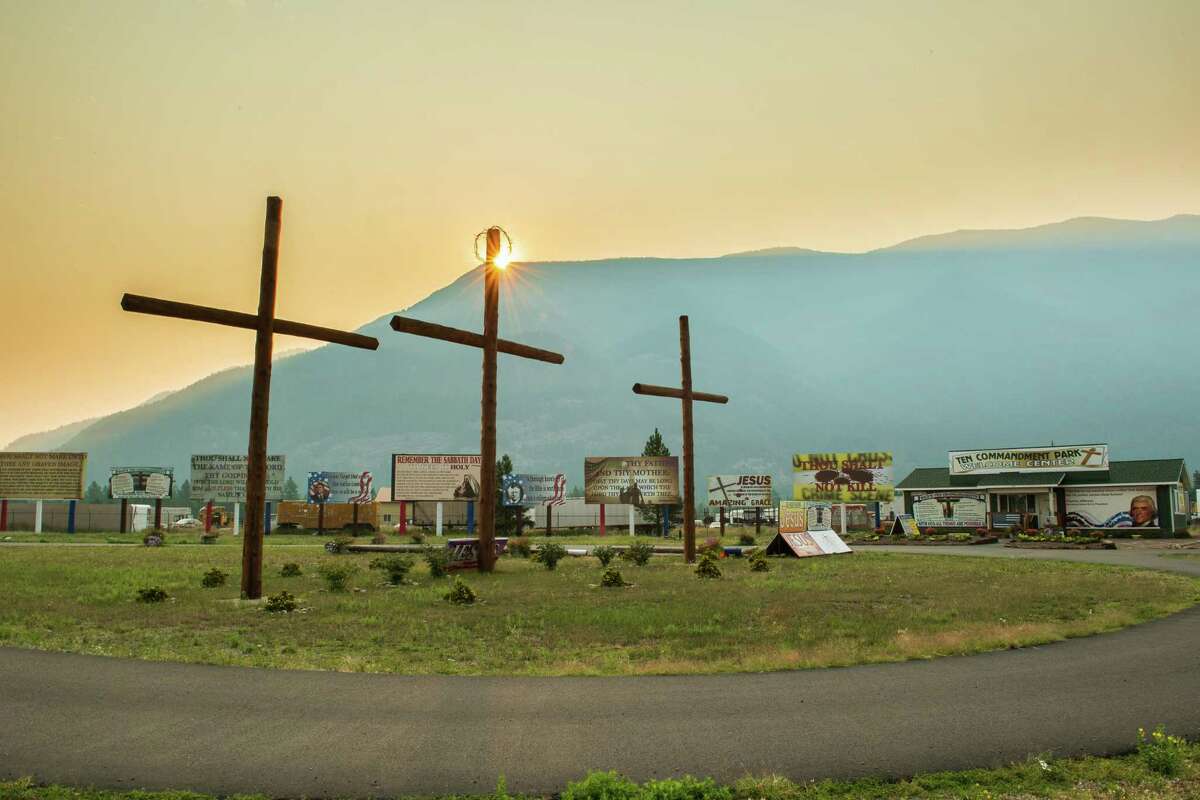 Billboards and crosses in the shadow of Columbia Mountain in Montana.