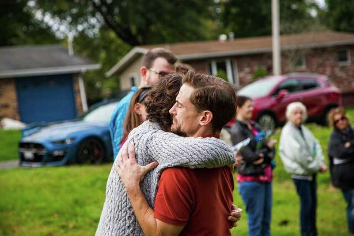 Collinsville resident Joseph Lama hugs Carrie Wolf, widow of Christian Wolf Saturday at a groundbreaking ceremony. Joseph and his family will get a new house through Lewis & Clark Habitat for Humanity’s “Build for the Cure.”