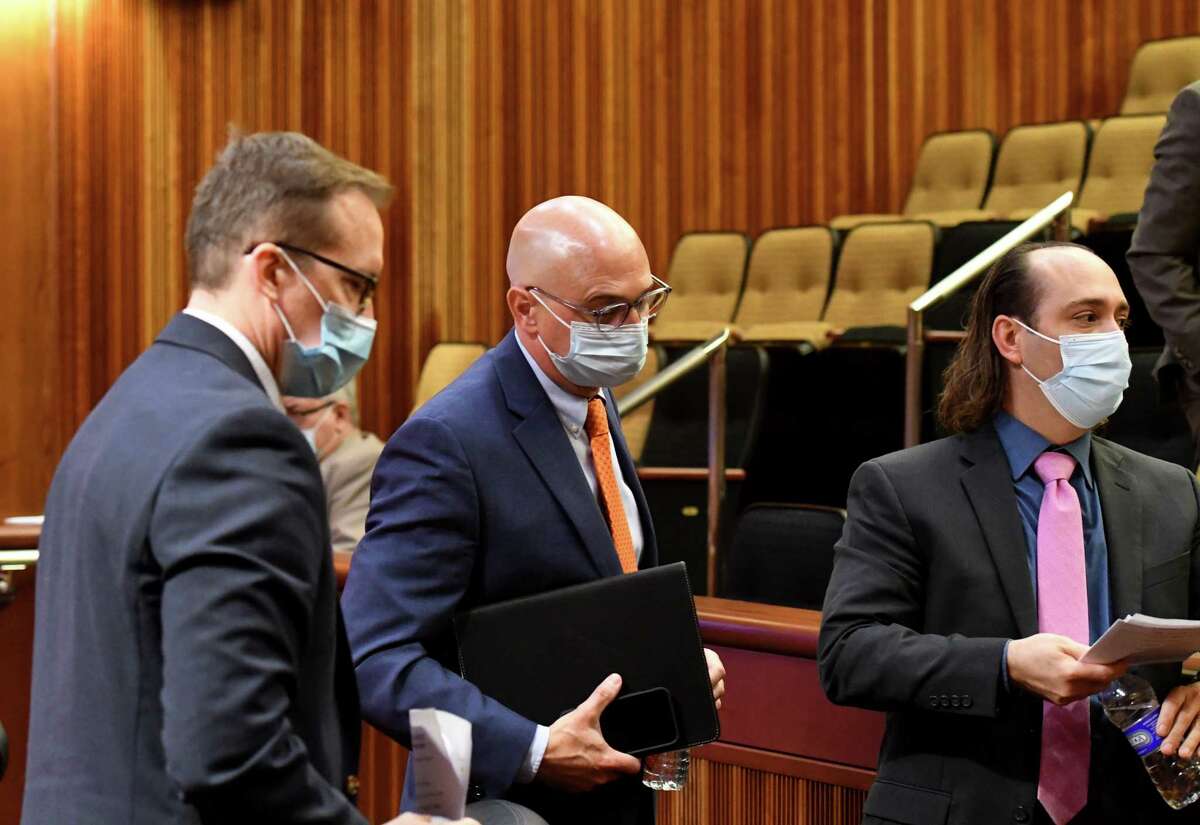 New York State Association of Counties Executive Director Stephen Acquario, center, leaves the panel after testifying in an Assembly hearing on the COVID-19 pandemic?•s impact on the open meetings law on Monday, Oct. 25, 2021, at the Legislative Office Building in Albany, N.Y.