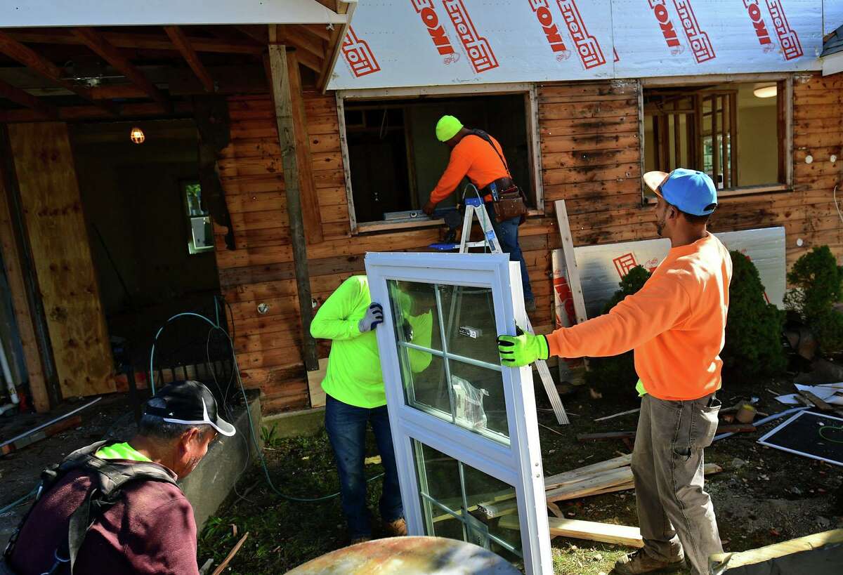 Construction workers renovate Colonial Village public housing buildings Thursday, October 21, 2021, in Norwalk, Conn. The Norwaklk Housing Authority has requested an extension on permits for the renovations first approved last fall.