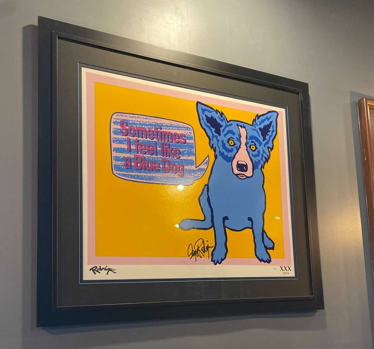 At Roux, a “Blue Dog” portrait by Louisiana artist George Rodrigue hangs on the wall, based on the Cajun legend, the loup-garou (a mythical werewolf-like creature)