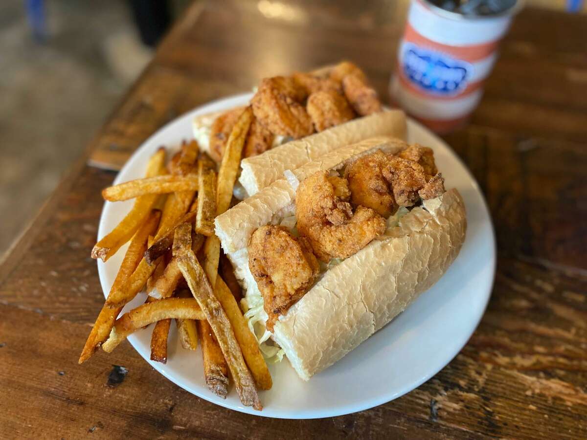 A fried shrimp po’boy, made with Gulf shrimp and served with tartar sauce, lettuce, tomato and fries.