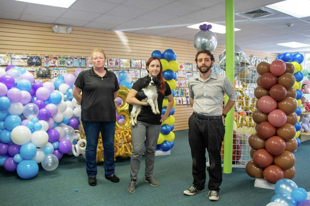 Beach Party Balloons is one of the businesses that signed up to be part of the Milford Chamber of Commerce I Love Local program. Pictured from left is Jess Greifzu, store owner, Melissa Bertrand with her dog, Stella, and Chris Edwards.