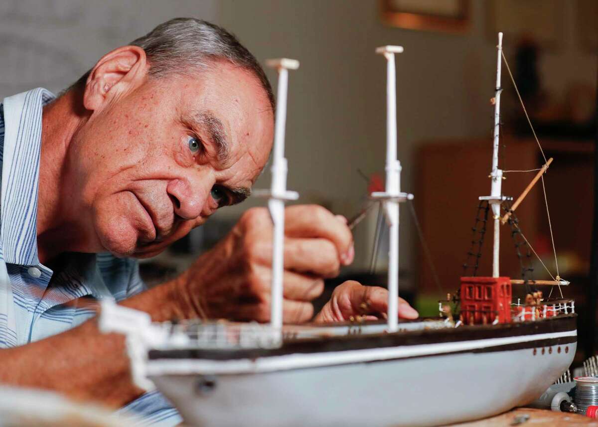 Philip Pfaff uses tweezers to tie rigging on a model of the 1877 Tall Ship Elissa, at his April Sound home, Tuesday, Oct. 19, 2021, in Montgomery. Pfaff’s models of the USS Philadelphia, a gunboat in the Continental Navy constructed in 1776 during the American Revolutionary War, was selected by the U.S. Navy to be housed in the Naval Academy’s Nimitz Library.