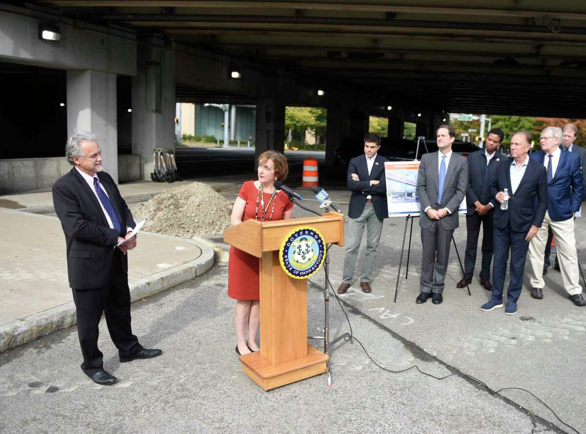 State Transportation Commissioner Joseph Giulietti, left, and Metro-North President Catherine Rinaldi, second from left, speak at the ground-breaking ceremony of the new parking garage at the Stamford Transportation Center in Stamford, Conn. Monday, Oct. 25, 2021. The garage is anticipated to be completed in the spring of 2023 and have parking for approximately 960 vehicles. Connecticut Gov. Ned Lamont was joined by U.S. Rep. Jim Himes, D-Conn., state Transportation Commissioner Joseph Giulietti, Metro-North President Catherine Rinaldi, and other local officials at the groundbreaking.