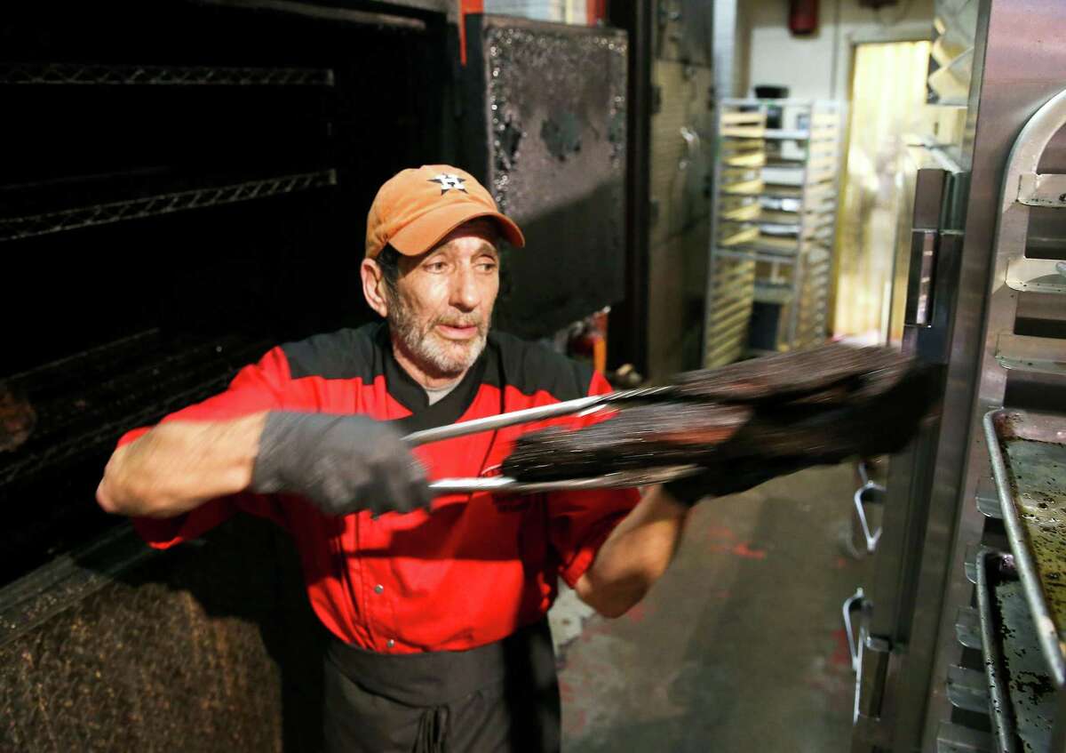 Jackson Street BBQ pit master Steve Ryan, works on some brisket at the restaurant in Houston on Monday, Oct. 25, 2021. The World Series is a financial boom for the restaurant, which is located across the street from Minute Maid Park.