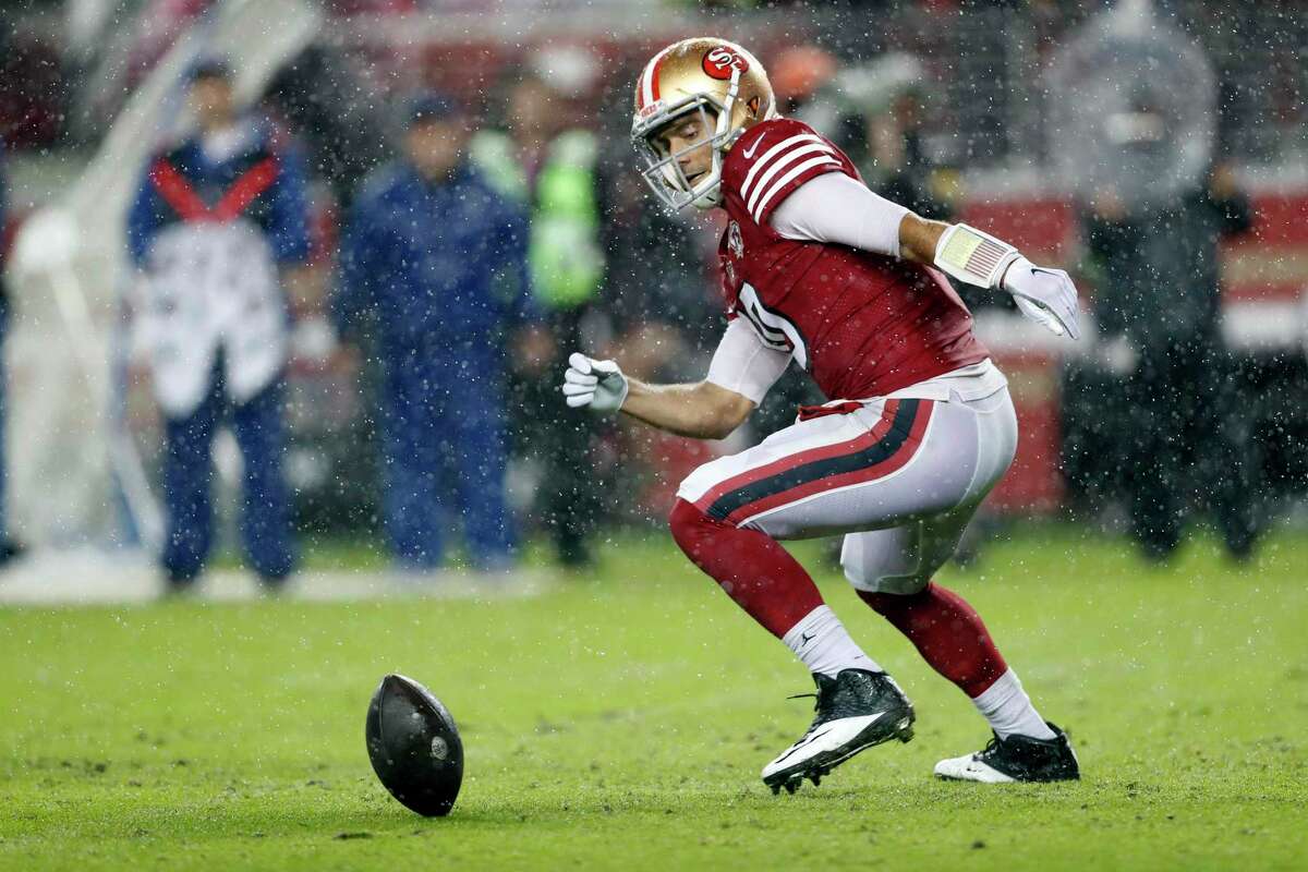 Quarterback Jimmy Garoppolo chases a botched snap during the 49ers’ 30-18 Sunday night loss to Indianapolis at Levi's Stadium.