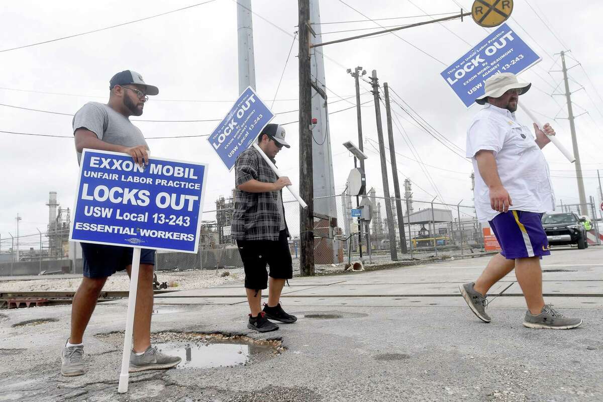 Locked out United Steel Workers Union members, including (from left) Carlos Soto, Adam Benavides and Zachary Simon, take their shift picketing outside Beaumont's ExxonMobil plant on Labor Day. Photo made Monday, September 6, 2021 Kim Brent/The Enterprise