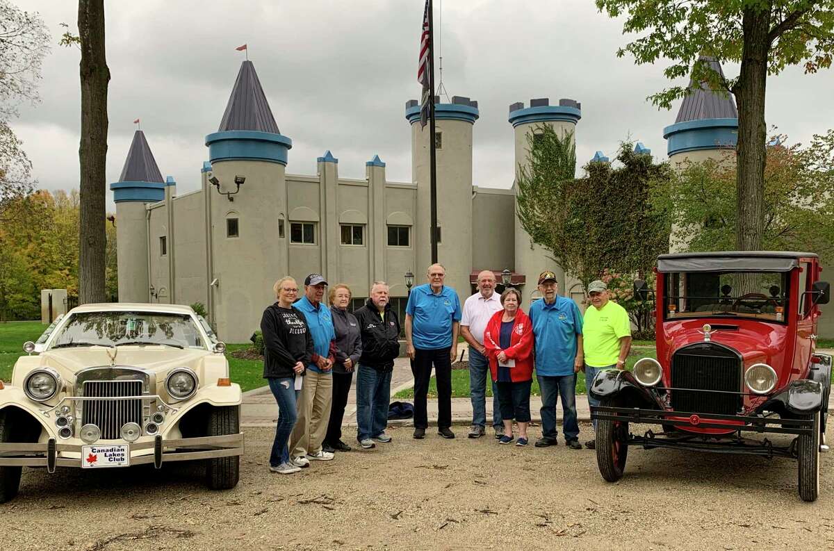 Pictured, from the left, is: Kim Easler from Angels of Action, CL Car Club members Jim Brand, Sandy Weir, Jim Kinnie, Marshall Henry, Robert Burtch from WISE and Car Club member, Diane Diehm from Mid Michigan Honor Flight, CL Car Club members: Leon Motz and Bruce Fredrick. (Courtesy photo)