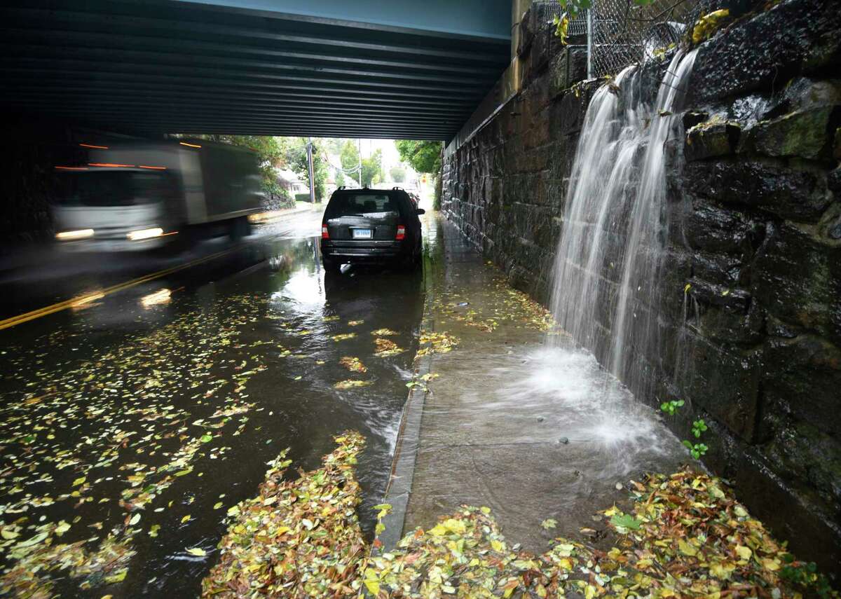 Heavy rain causes flooding under the train bridge in the Byram section of Greenwich, Conn. Tuesday, Oct. 26, 2021. A nor'easter hit the area Tuesday with heavy rain causing flooding and downed trees.