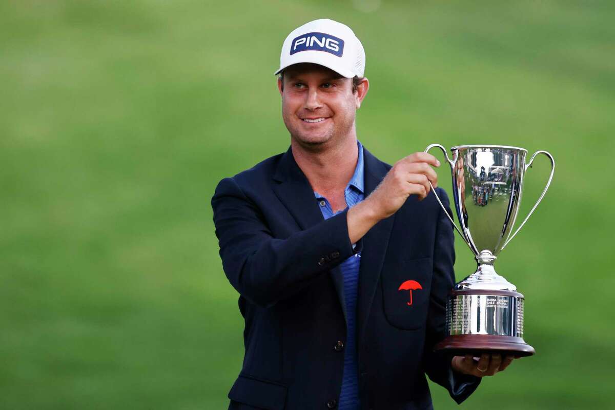 Harris English poses with the trophy after winning the Travelers Championship on the eighth playoff hole over Kramer Hickok (not pictured) at TPC River Highlands on June 27. The Travelers Championship raised $2.2M for charities this year.