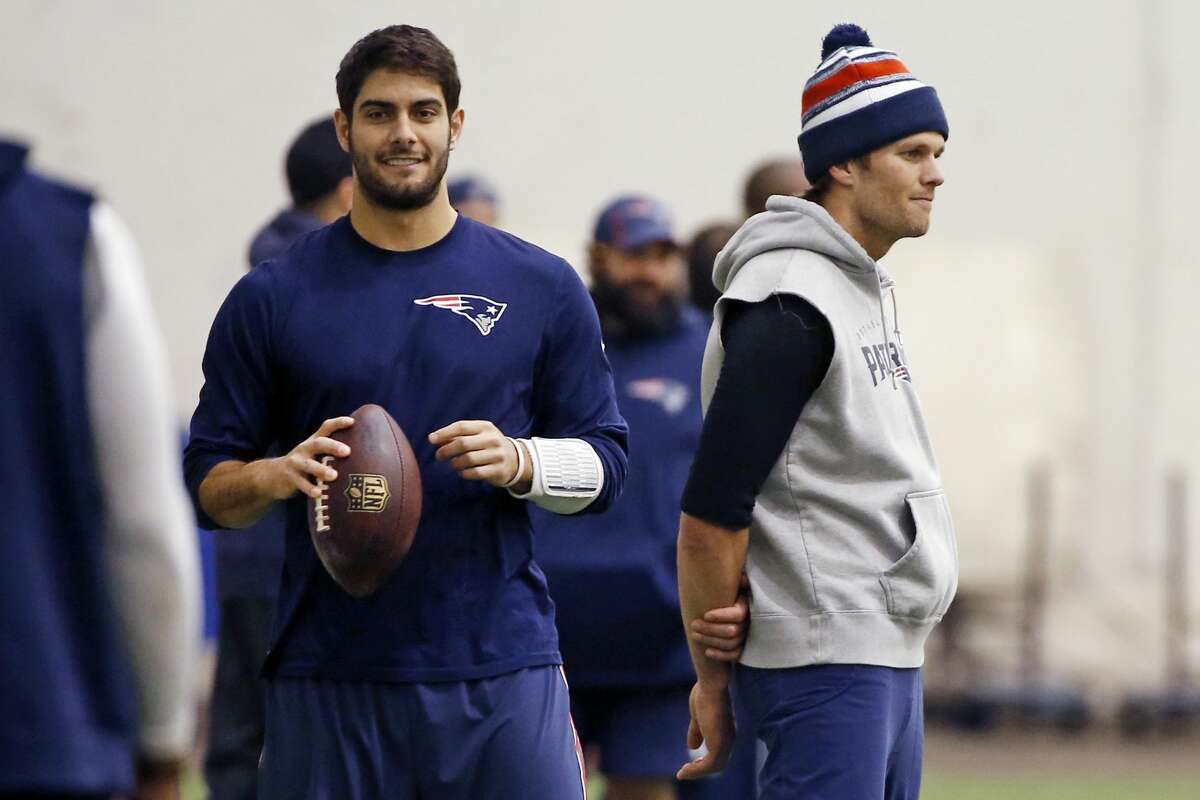 FILE- In this Feb. 1, 2015, file photo, New England Patriots then-backup quarterback Jimmy Garoppolo, left, holds a football as quarterback Tom Brady, right, stands nearby. (AP Photo/Elise Amendola, File)