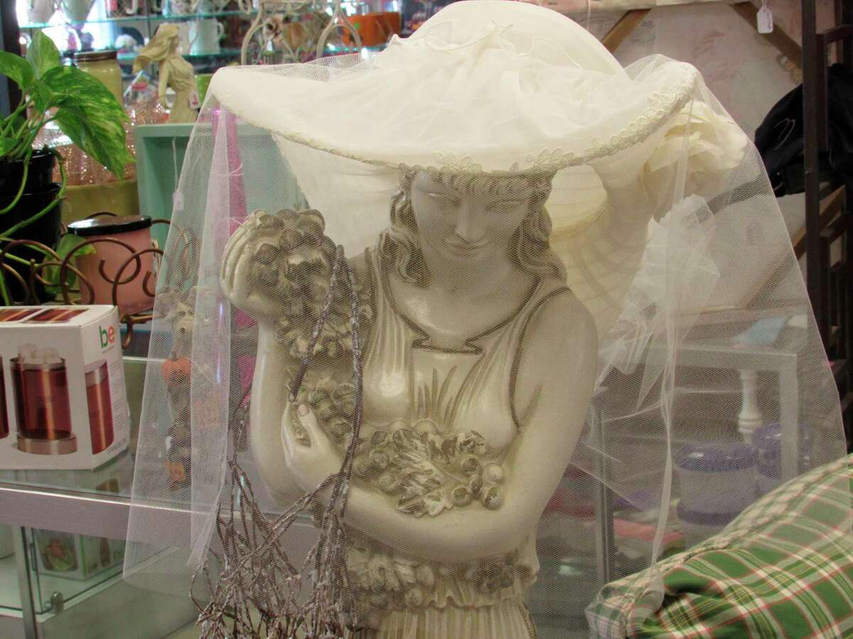 A statue, originally from Merle Norman Cosmetics and Wigs, stands amid the wares at Northern Belle. Shop owner Debrina Dexter named the figure "Rita" in honor of Rita Tyrrell, who owned Midland's Merle Norman store. (Victoria Ritter/vritter@mdn.net)