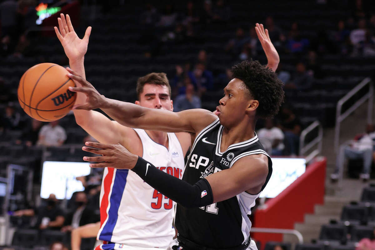 Joshua Primo #11 of the San Antonio Spurs passes away from Luka Garza #55 of the Detroit Pistons during a preseason game at Little Caesars Arena on October 06, 2021 in Detroit, Michigan.