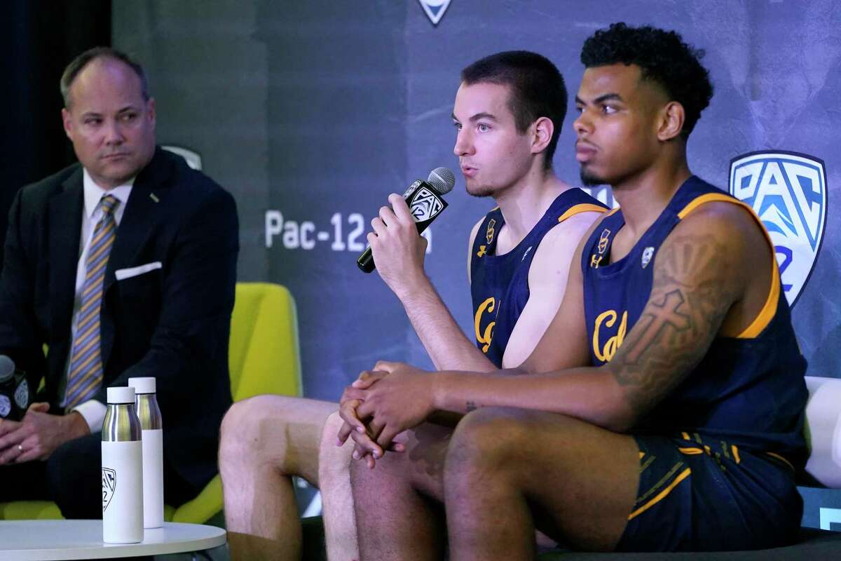 California head coach Mark Fox, left, listens as Grant Anticevich, center, speaks next to Andre Kelly during the Pac-12 Conference NCAA college basketball media day Wednesday, Oct. 13, 2021, in San Francisco. (AP Photo/Jeff Chiu)