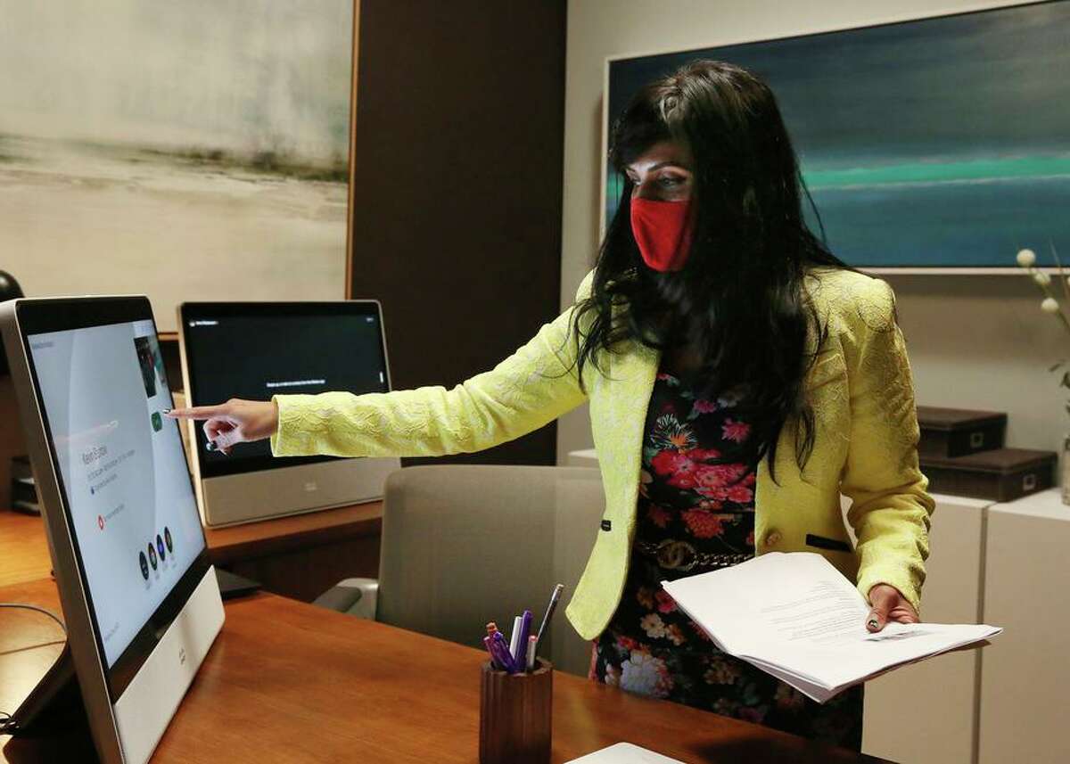 Aruna Ravichandran, Webex’s chief marketing officer, demonstrates a Webex Desk Pro on a home office set.