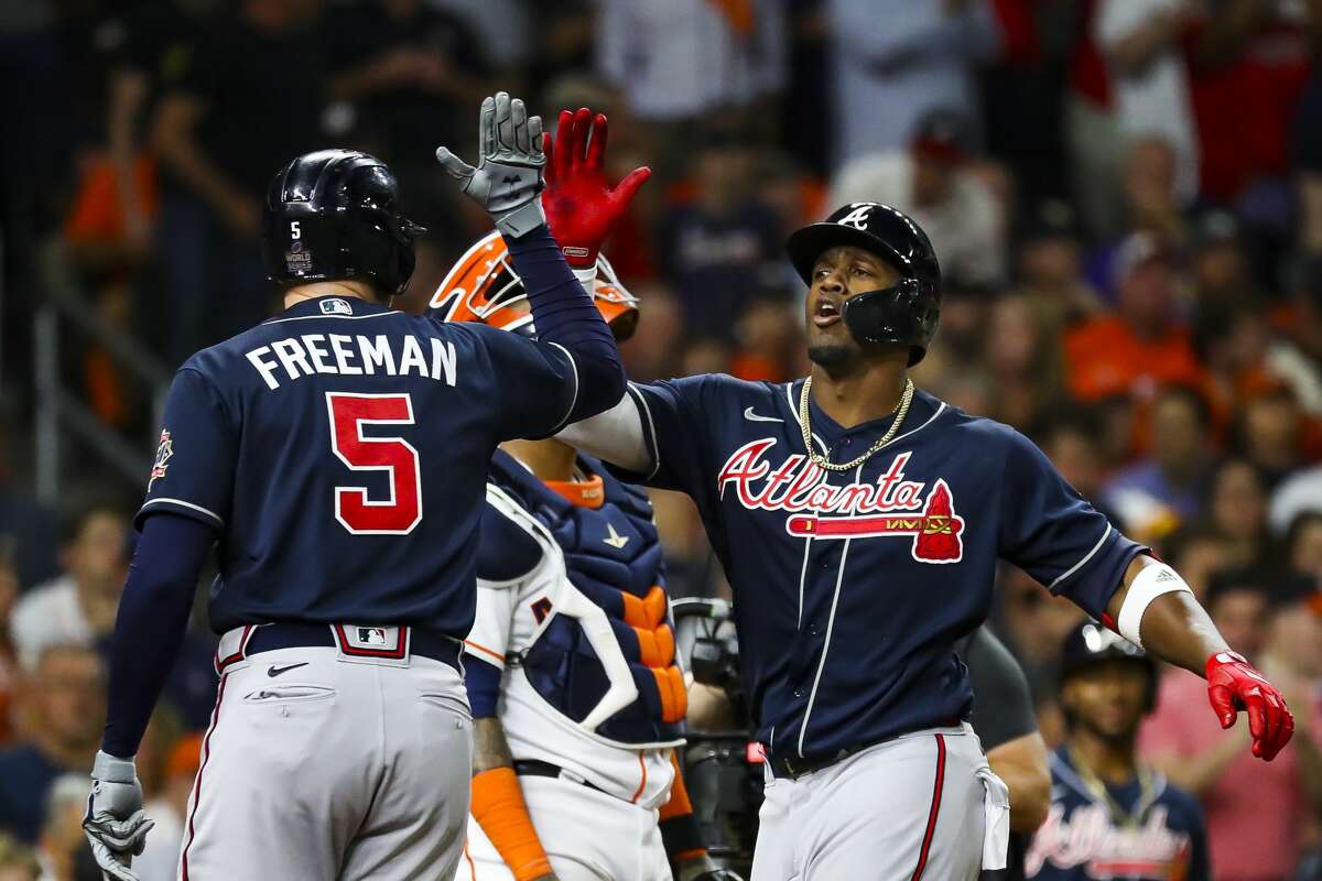Atlanta Braves right fielder Jorge Soler (12) celebrates his solo home run with Atlanta Braves first baseman Freddie Freeman (5) to start the first inning in Game 1 of the World Series on Tuesday, Oct. 26, 2021 at Minute Maid Park in Houston.