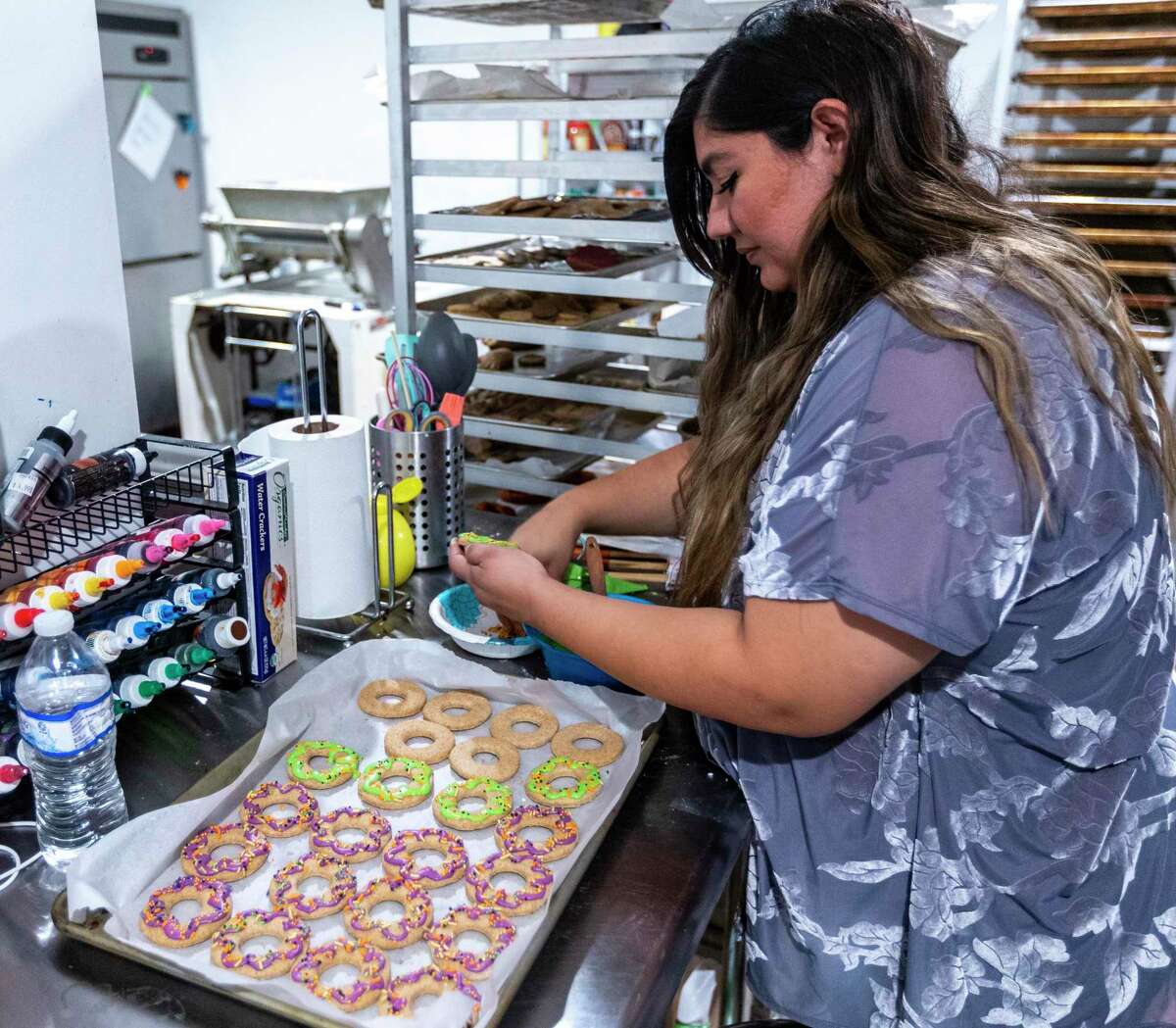Alexis Quiroga, owner of Pawsitively Sweet Bakery, makes cookies for pets Oct. 21, 2021 in her Blanco Road shop.