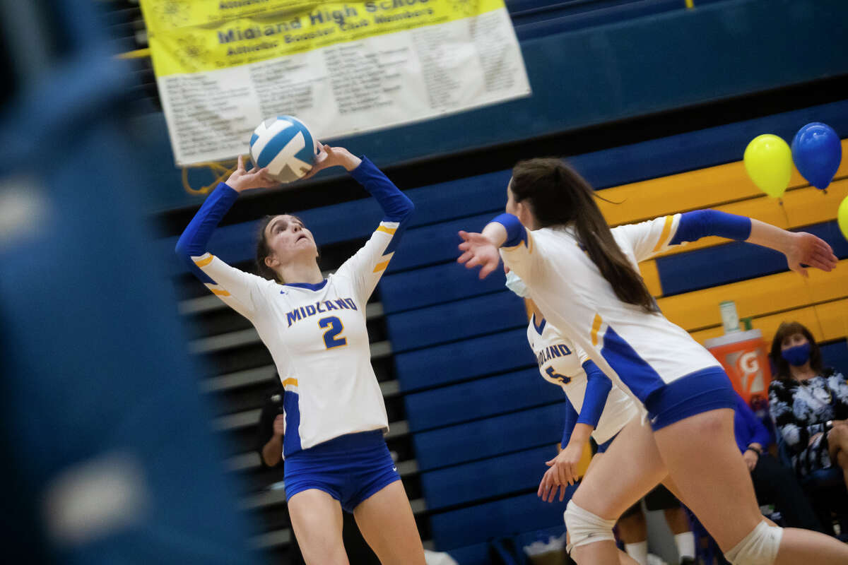 Midland's Olivia McMath sets the ball during the Chemics' game against Dow Tuesday, Oct. 26, 2021 at Midland High School. (Katy Kildee/kkildee@mdn.net)