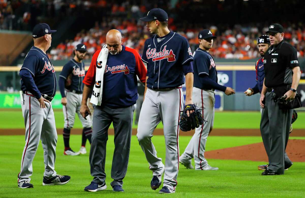 Atlanta Braves starting pitcher Charlie Morton (50) walks off of the field with a Braves trainer after sustaining an injury during the third inning in Game 1 of the World Series on Tuesday, Oct. 26, 2021 at Minute Maid Park in Houston.