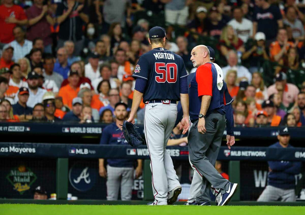 Atlanta Braves starting pitcher Charlie Morton (50) walks off of the field with a Braves trainer after sustaining an injury during the third inning in Game 1 of the World Series on Tuesday, Oct. 26, 2021 at Minute Maid Park in Houston.