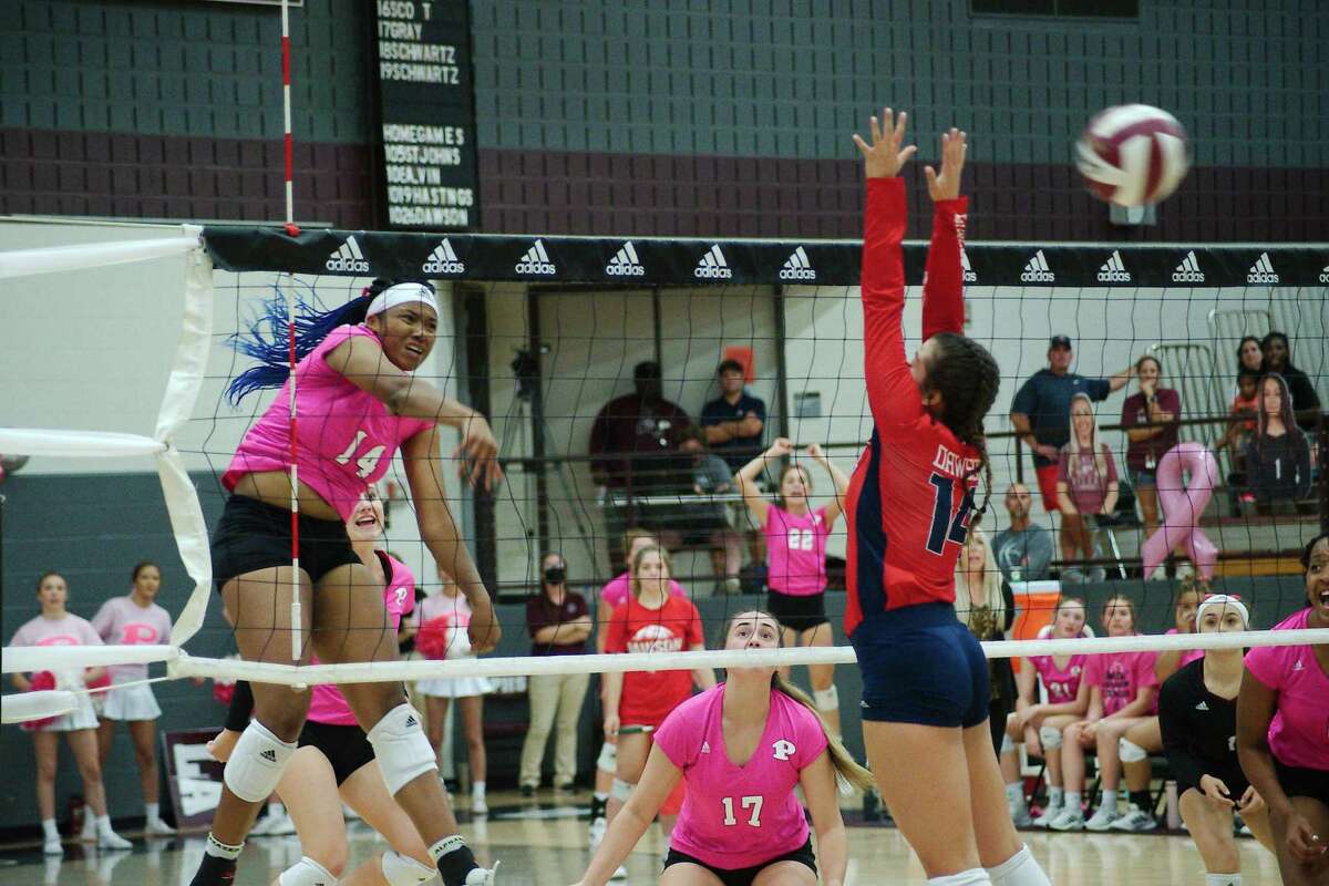 Pearland’s Aryelle Stevens (14) blasts a shot past Dawson’s Kylie Nance (14) Tuesday, Oct. 26, 2021 at Pearland High School.