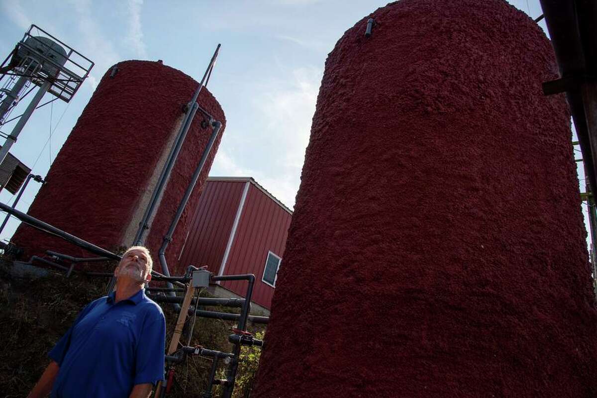 Albert Straus, CEO of Straus Family Creamery, stands beside a pair of tanks that are part of his farm’s methane digester system, at the Straus Dairy Farm in the Marin County community of Marshall.