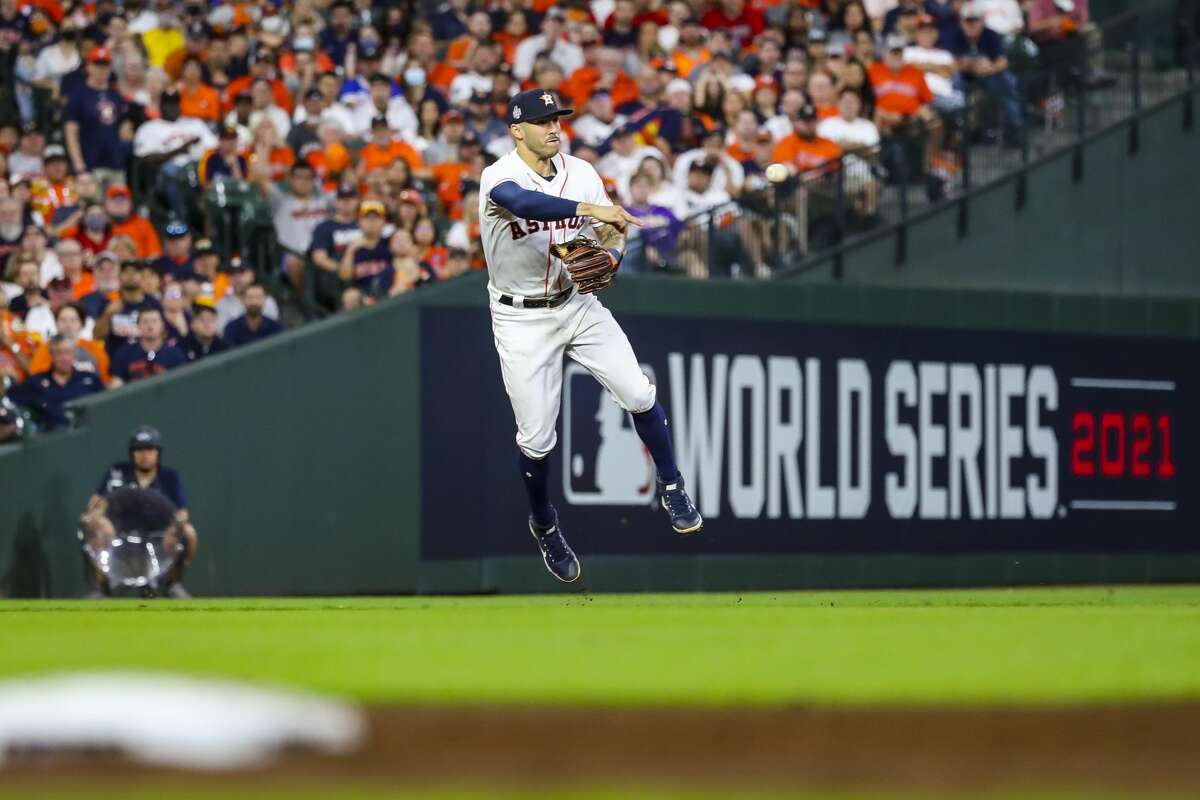 Houston Astros shortstop Carlos Correa (1) turns a double play during the seventh inning in Game 1 of the World Series on Tuesday, Oct. 26, 2021 at Minute Maid Park in Houston.