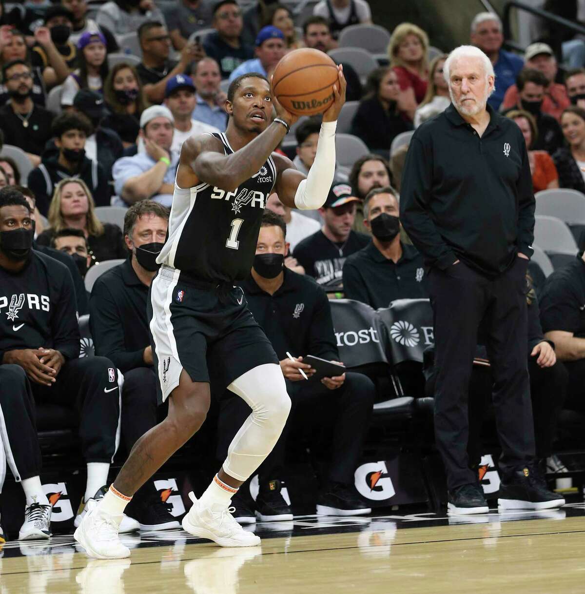Spurs' Lonnie Walker IV (01) lines up a three-pointer as Spurs head coach Gregg Popovich looks on during the game against the Lakers at the AT&T Center on Tuesday, Oct. 26, 2021.