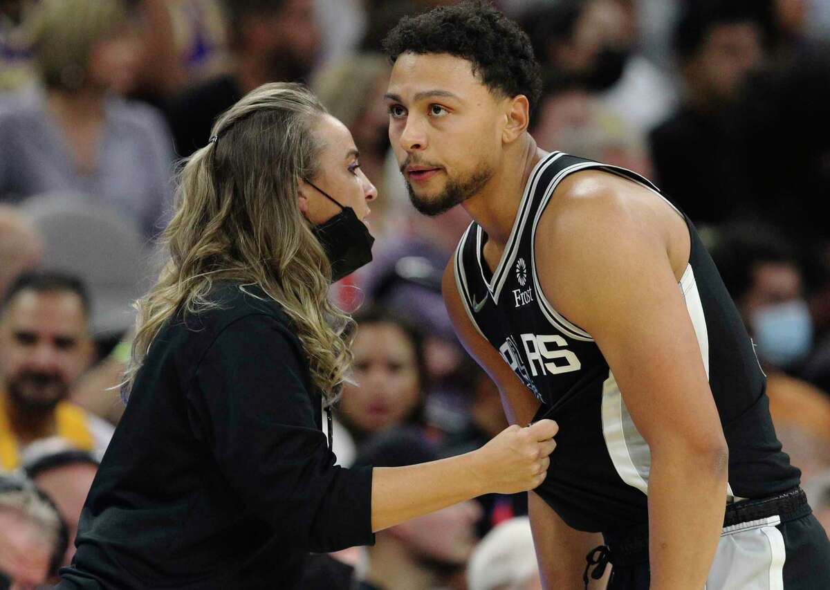 Assistant coach Becky Hammon, talking with Bryn Forbes during a game against the Lakers at the AT&T Center, is one of several Spurs players or staffers to have contracted COVID-19.