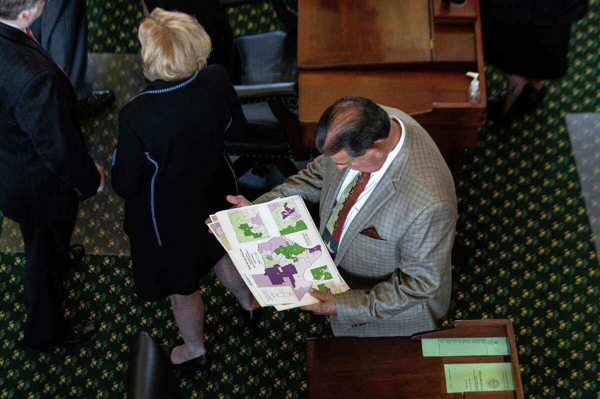 State Sen. Eddie Lucio Jr., D-Brownsville, looks at a map of state Senate districts in the Senate chamber on the first day of the 87th Legislature's third special session. The Mexican American Legislative Caucus has filed a suit that says the new state House map violates the Texas Constitution. Its challenge centers on the reconfiguration of Cameron County in the Rio Grande Valley, which breaks the county line twice to create three districts — only one wholly contained within the county.