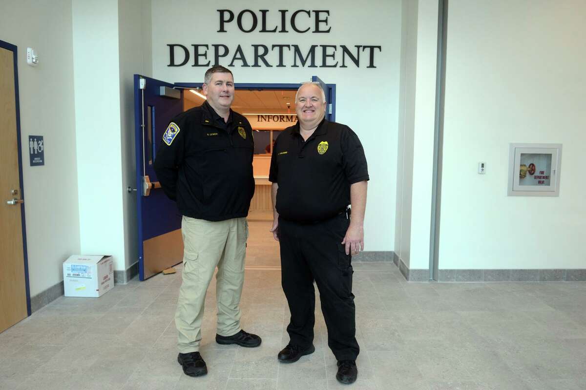 Acting Police Chief Wayne Williams, right, and Lt. Patrick Lynch pose in front of the new Ansonia Police Headquarters, in Ansonia, Conn. Oct. 26, 2021.
