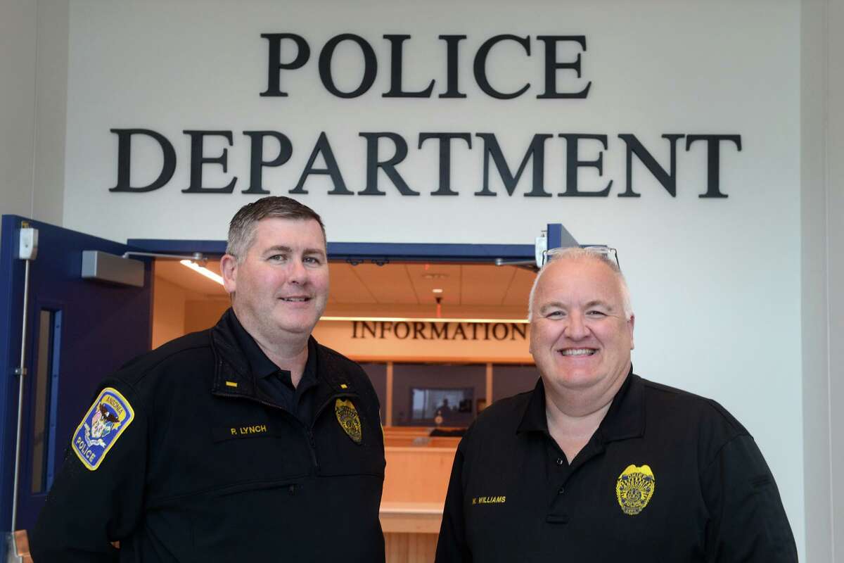 Acting Police Chief Wayne Williams, right, and Lt. Patrick Lynch pose in front of the new Ansonia Police Headquarters, in Ansonia, Conn. Oct. 26, 2021.
