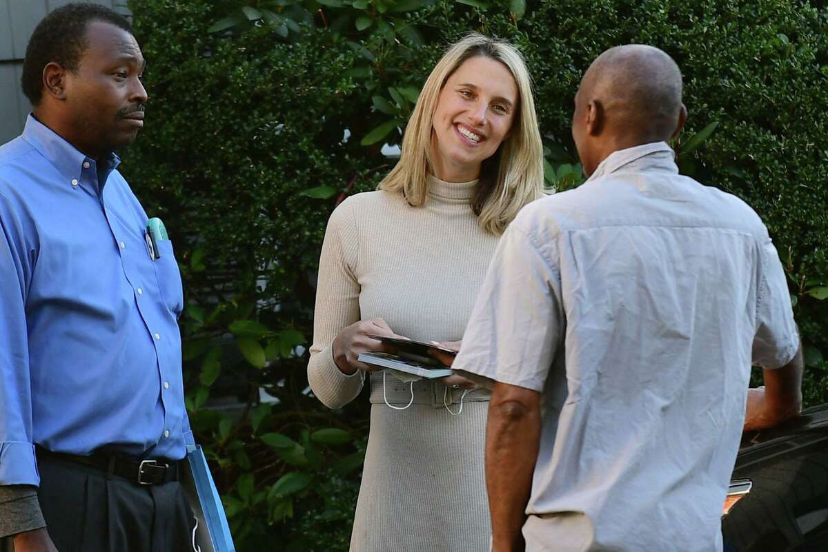 Mayoral candidate Caroline Simmons campaigns along Elaine Drive with Board of Representatives candidate Fred Pierre-Louis, not pictured, on Wednesday in Stamford.
