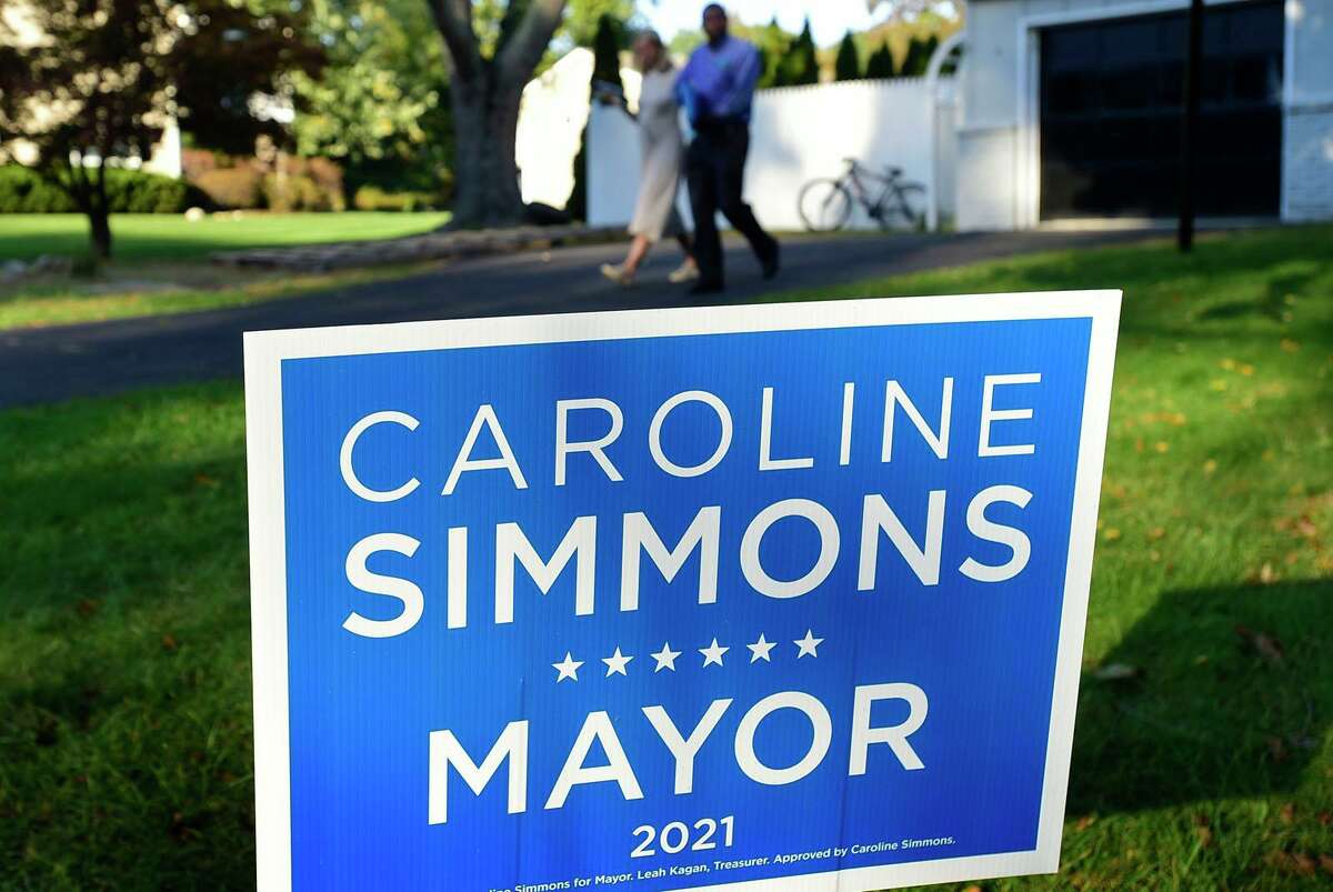 Mayoral candidate Caroline Simmons campaigns along Elaine Dr. with board of representatives candidate Fred Pierre-Louis Wednesday, October 20, 2021, in Stamford, Conn.