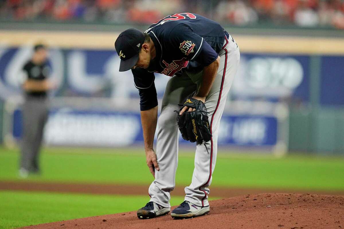 Atlanta Braves starting pitcher Charlie Morton rubs his leg before leaving the game during the third inning of Game 1 in baseball's World Series between the Houston Astros and the Atlanta Braves Tuesday, Oct. 26, 2021, in Houston. (AP Photo/Ashley Landis)