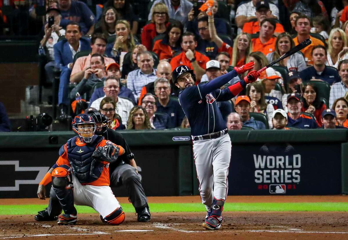 Atlanta Braves catcher Travis d'Arnaud (16) hits a solo home run to tie the game 1-1 during the second inning in Game 2 of the World Series on Wednesday, Oct. 27, 2021 at Minute Maid Park in Houston.