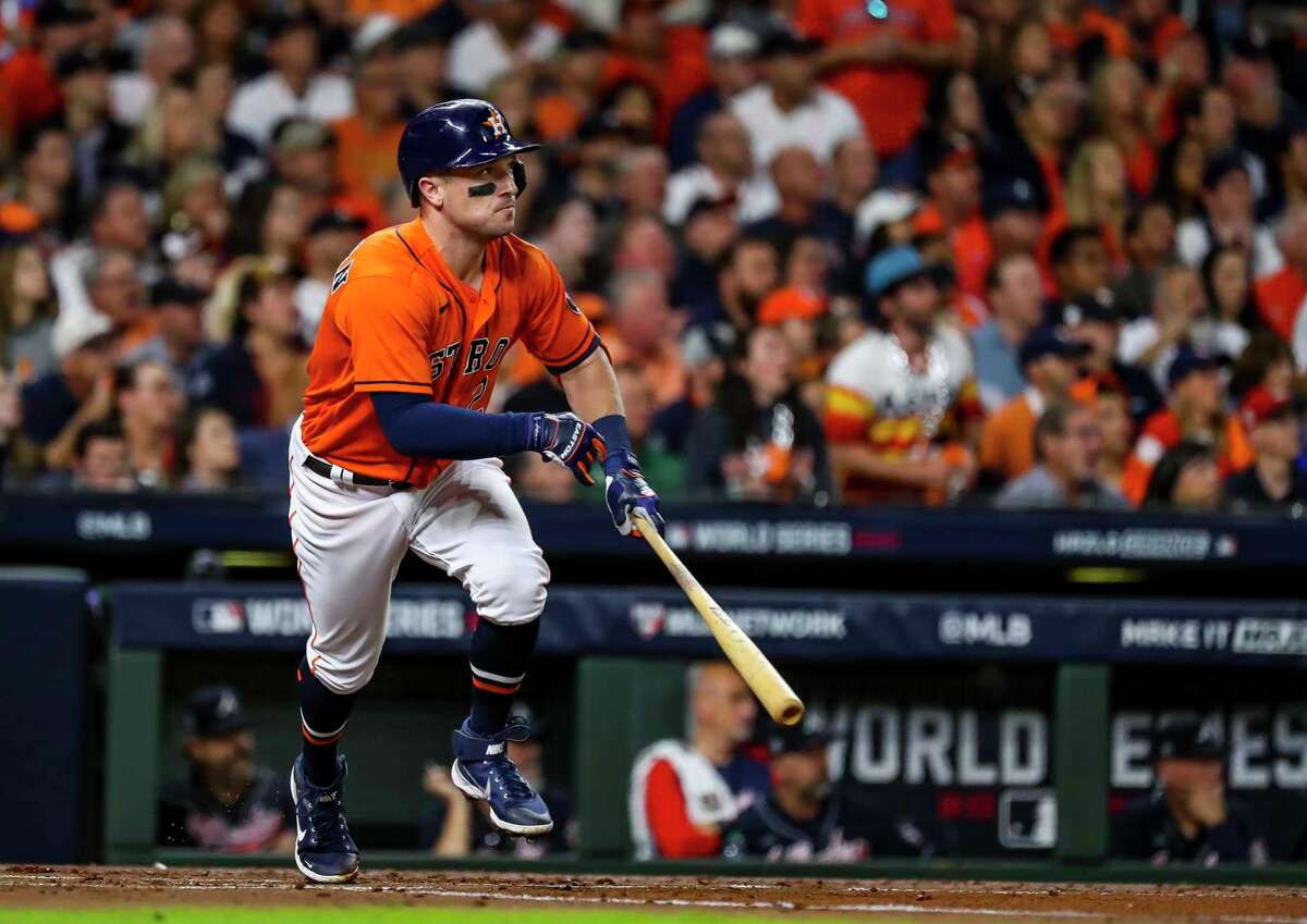 Houston Astros third baseman Alex Bregman (2) hits a sacrifice fly that scores Houston Astros second baseman Jose Altuve (27) during the first inning in Game 2 of the World Series on Wednesday, Oct. 27, 2021 at Minute Maid Park in Houston.